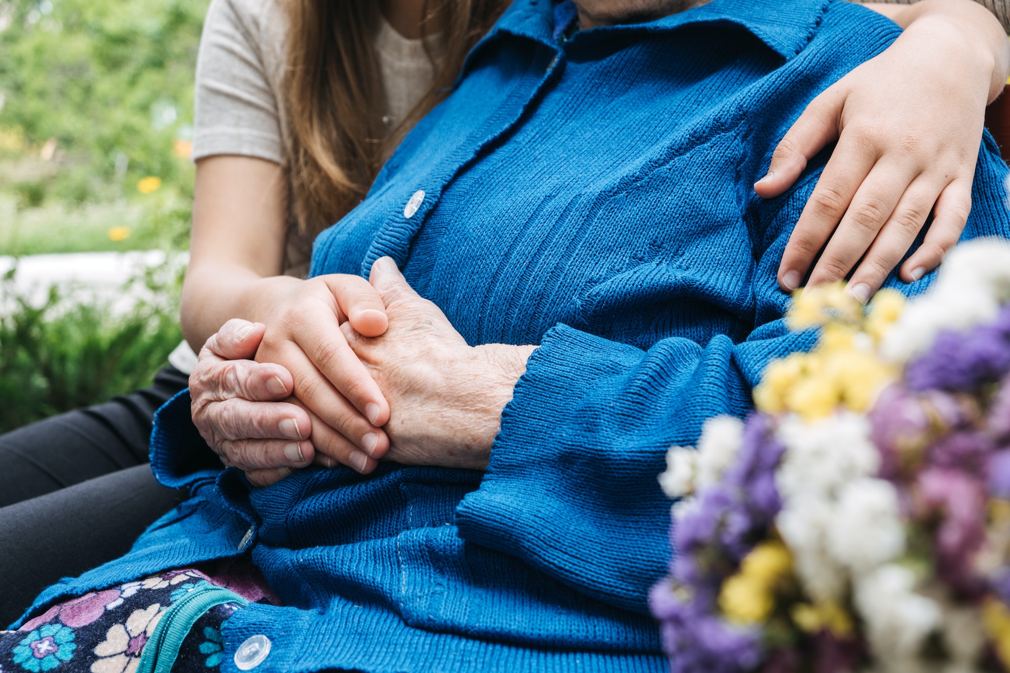 Young hands holding old elderly senior hands. Support for the seniors